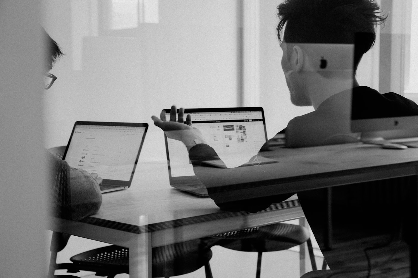 Contractor reviewing marketing ROI on a laptop with a phone ringing